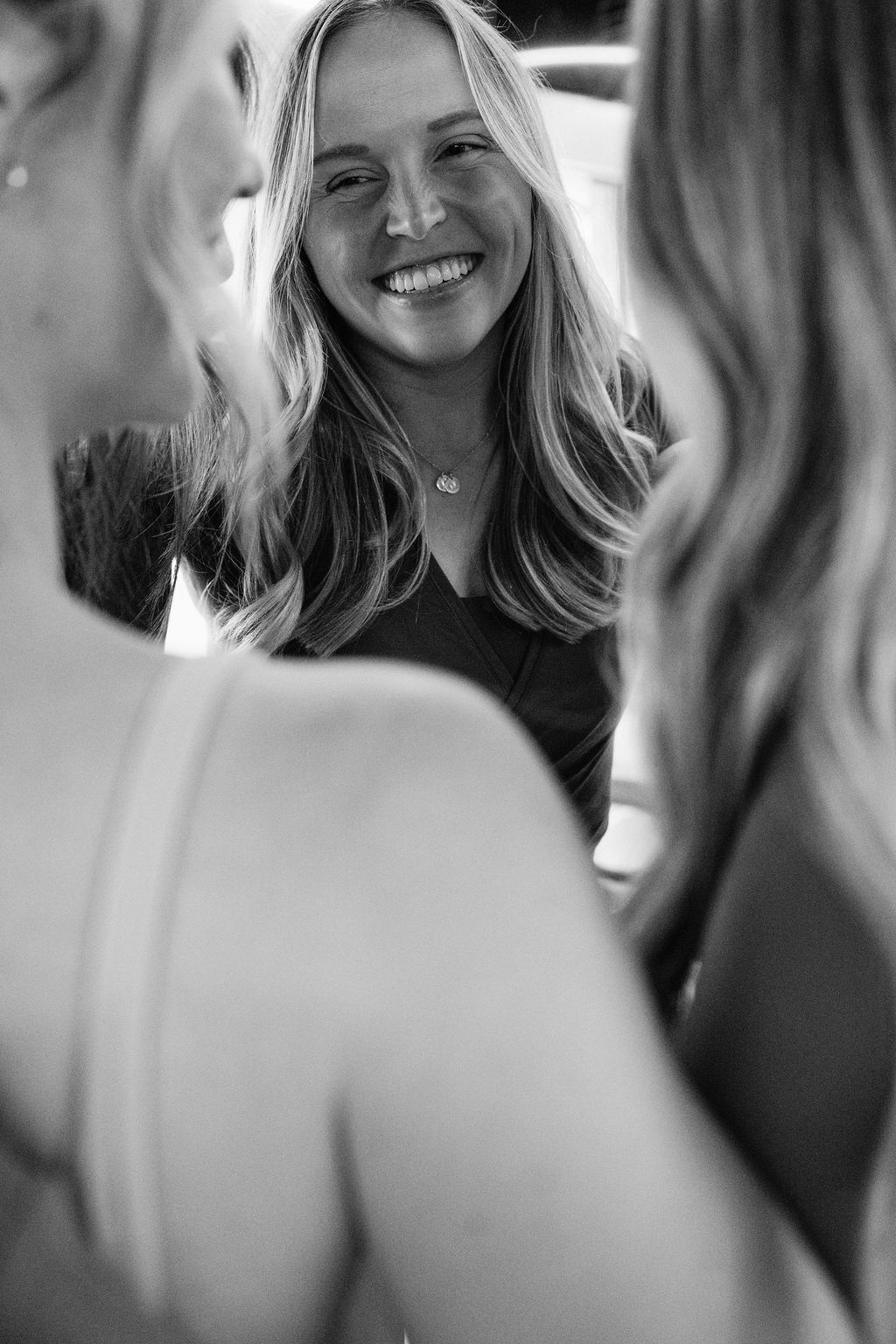 Three Core Collective members smiling and hugging in the studio